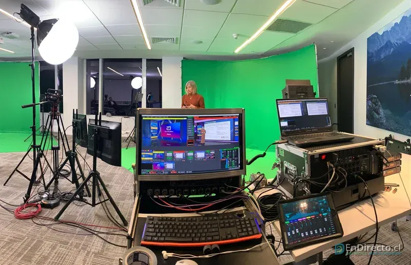 Vista general del estudio virtual: presentadora frente al chroma, luces, cámaras y control de producción
